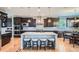 Beautiful kitchen with dark cabinets, granite countertops, an island with bar seating, and stainless steel appliances at 23503 E Minnow Dr, Aurora, CO 80016