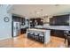 Spacious kitchen features dark cabinets, granite countertops, a center island, and stainless steel appliances at 23503 E Minnow Dr, Aurora, CO 80016