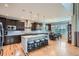 Open kitchen boasts dark cabinetry, granite counters, an island with seating, and an adjacent dining area at 23503 E Minnow Dr, Aurora, CO 80016