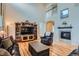 Cozy living room featuring hardwood floors, a fireplace, and high ceilings at 23503 E Minnow Dr, Aurora, CO 80016