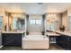 Bathroom features a large soaking tub, dark cabinets, and dual vanity sinks at 23503 E Minnow Dr, Aurora, CO 80016