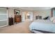 Spacious main bedroom featuring classic furniture and a light-filled doorway to the hall at 23503 E Minnow Dr, Aurora, CO 80016