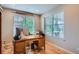 Bright office with hardwood floors, a large desk, and natural light streaming through the window at 23503 E Minnow Dr, Aurora, CO 80016
