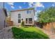 A well-maintained backyard featuring a small deck and lush green grass provides a private outdoor retreat at 1272 Braewood Ave, Highlands Ranch, CO 80129