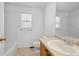 Bright bathroom featuring a large mirror, oak vanity, and shower-tub combination at 1272 Braewood Ave, Highlands Ranch, CO 80129