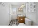 Bathroom features patterned tile floor, window and double sink vanity at 1272 Braewood Ave, Highlands Ranch, CO 80129