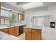 Bright kitchen with wood cabinets and stainless appliances which opens to the living area at 1272 Braewood Ave, Highlands Ranch, CO 80129