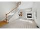 Bright living room with a fireplace, large windows, and a staircase leading to the second floor at 1272 Braewood Ave, Highlands Ranch, CO 80129