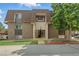 A brick apartment building with a well-maintained lawn and mature trees adding to the property's curb appeal at 7755 E Quincy Ave # 107D2, Denver, CO 80237