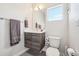 Modern half bathroom with gray wood vanity, white countertop, and a modern sink at 5531 W 11Th Pl, Lakewood, CO 80214