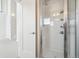 Modern bathroom featuring tiled shower and glass door with visible shelving at 5531 W 11Th Pl, Lakewood, CO 80214