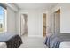 Bright bedroom featuring two closets and two doors leading to other parts of the home at 5531 W 11Th Pl, Lakewood, CO 80214