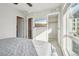 Bright bedroom with a walk-in closet, a mounted television, and light-colored walls at 5531 W 11Th Pl, Lakewood, CO 80214