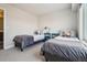 Well-lit bedroom with two twin beds, gray bedding, and simple bedside tables at 5531 W 11Th Pl, Lakewood, CO 80214