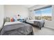 Cozy bedroom featuring twin beds and a large window, perfect for a ' room or guest room at 5531 W 11Th Pl, Lakewood, CO 80214