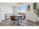 Dining area with wood table, seating for four, and a large window with lots of natural light at 5531 W 11Th Pl, Lakewood, CO 80214