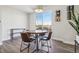 Bright dining area features a wooden table, chairs, and a large window with neighborhood views at 5531 W 11Th Pl, Lakewood, CO 80214