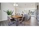 Dining area with wood table, seating for four, and view of the open concept main floor at 5531 W 11Th Pl, Lakewood, CO 80214