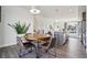 Charming dining area with a round wooden table, seating for four, and modern pendant lighting at 5531 W 11Th Pl, Lakewood, CO 80214