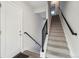 Inviting entryway with modern staircase featuring stylish railing and neutral carpet, leading to the upper levels at 5531 W 11Th Pl, Lakewood, CO 80214