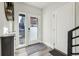 Bright entryway featuring wood-look flooring, a white door with glass, and a view of the outside at 5531 W 11Th Pl, Lakewood, CO 80214