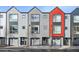 Modern townhomes with gray siding and a pop of color showcasing unique architectural design at 5531 W 11Th Pl, Lakewood, CO 80214