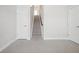 Hallway with carpeted stairs leading to the upper level and several entry doors at 5531 W 11Th Pl, Lakewood, CO 80214