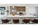 Modern kitchen featuring stainless steel appliances, a white countertop island, and bar stool seating at 5531 W 11Th Pl, Lakewood, CO 80214