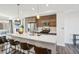 Modern kitchen featuring stainless steel appliances, wooden cabinets, and a large white countertop island with seating at 5531 W 11Th Pl, Lakewood, CO 80214