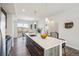 Bright kitchen with a large island, quartz countertops, stainless steel appliances, and an adjacent dining area at 5531 W 11Th Pl, Lakewood, CO 80214