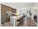 Bright kitchen features stainless steel appliances, wood cabinets, and a large island with bar seating at 5531 W 11Th Pl, Lakewood, CO 80214