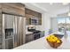 Modern kitchen featuring stainless steel appliances, sleek countertops, and wooden cabinets at 5531 W 11Th Pl, Lakewood, CO 80214