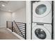 Hallway laundry closet with stacked washer and dryer units at 5531 W 11Th Pl, Lakewood, CO 80214