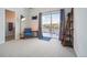 Cozy living room with gray carpet, blue accent chair and access to the balcony at 5531 W 11Th Pl, Lakewood, CO 80214