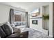 Cozy living room boasts a modern fireplace, large window, and comfortable leather seating at 5531 W 11Th Pl, Lakewood, CO 80214