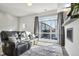 Inviting living room showcases a modern fireplace, large window, and stylish leather sofa at 5531 W 11Th Pl, Lakewood, CO 80214