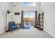 Bright living room featuring carpet, balcony access, and a decorative ladder shelf at 5531 W 11Th Pl, Lakewood, CO 80214