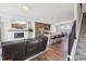 Open living space featuring a stylish living room, kitchen island with seating, and adjacent staircase at 5531 W 11Th Pl, Lakewood, CO 80214