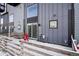 Back patio featuring outdoor seating, modern siding and snow-covered ground at 5531 W 11Th Pl, Lakewood, CO 80214