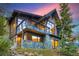 Luxury home with large windows and a deck, showcasing mountain views at 52 West Point Lode # A, Breckenridge, CO 80424