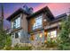 Mountain home exterior boasts a stunning design with stone and wood accents at 52 West Point Lode # A, Breckenridge, CO 80424