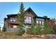 Two-story home with stone and wood exterior, multiple balconies, and a hot tub at 52 West Point Lode # A, Breckenridge, CO 80424