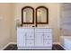 Double vanity bathroom with white cabinets and mirrors at 3338 S Canosa Ct, Englewood, CO 80110