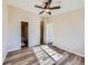 Well-lit bedroom with ceiling fan and access to bathroom at 3338 S Canosa Ct, Englewood, CO 80110