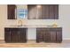 Modern kitchen with dark brown cabinets, granite countertops, and stainless steel sink at 3338 S Canosa Ct, Englewood, CO 80110