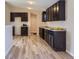 Modern kitchen with dark cabinetry and granite counters at 3338 S Canosa Ct, Englewood, CO 80110