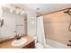 Cozy bathroom features a vanity with tiled countertops and a shower-tub with a white shower curtain at 1265 S Sherman St, Denver, CO 80210