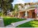 Inviting home exterior with a green lawn, manicured landscaping and covered front porch at 1265 S Sherman St, Denver, CO 80210