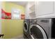 Efficient laundry room featuring front-loading washer and dryer, bright accents, and plenty of storage at 1265 S Sherman St, Denver, CO 80210