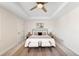 Spacious main bedroom features a tray ceiling and neutral tones, creating a serene and inviting atmosphere at 1265 S Sherman St, Denver, CO 80210